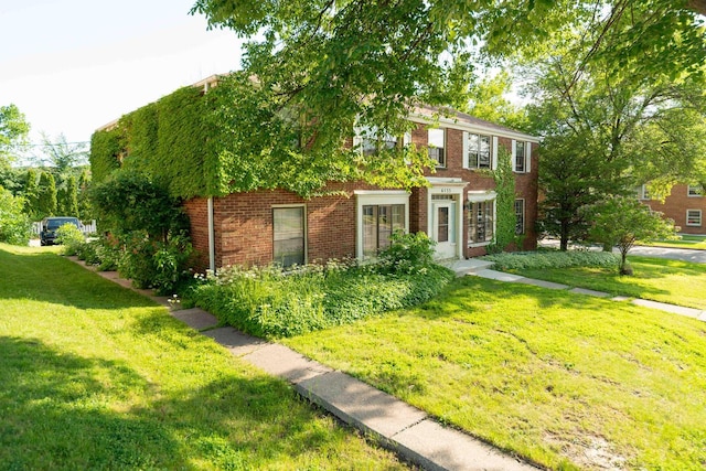 6533 W Center St, Wauwatosa, WI 53210 - view of front facade featuring a front yard and brick siding