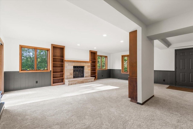 N113W20588 Edgewood Dr, Germantown, WI 53022 - unfurnished living room featuring carpet flooring, wainscoting, recessed lighting, a fireplace, and baseboard heating