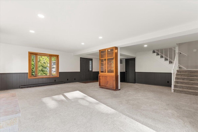 N113W20588 Edgewood Dr, Germantown, WI 53022 - unfurnished living room featuring a wainscoted wall, carpet flooring, baseboard heating, stairway, and recessed lighting