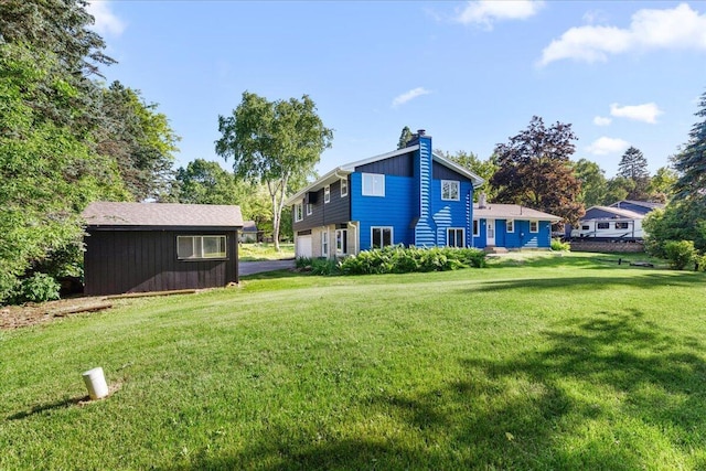 N113W20588 Edgewood Dr, Germantown, WI 53022 - rear view of property with a chimney and a yard