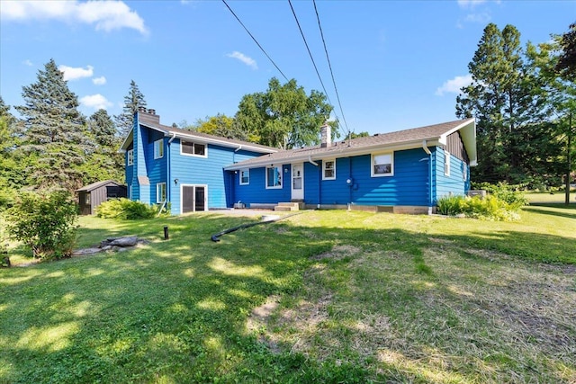 N113W20588 Edgewood Dr, Germantown, WI 53022 - back of house featuring a chimney and a yard