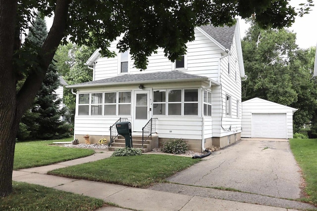 514 Robert St, Fort Atkinson, WI 53538 - view of front of home with an outbuilding, entry steps, driveway, a shingled roof, and a front yard