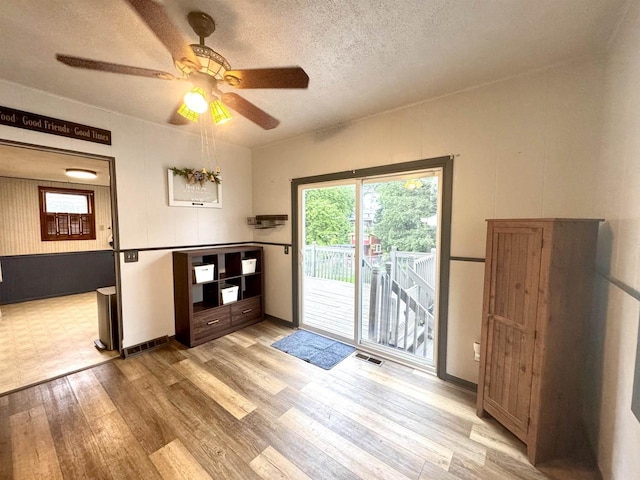 514 Robert St, Fort Atkinson, WI 53538 - unfurnished dining area featuring wood finished floors, ceiling fan, and a textured ceiling