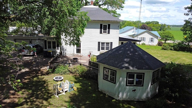 N3225 County Road K, Mauston, WI 53948 - back of property with a shingled roof, a yard, a chimney, and a wooden deck
