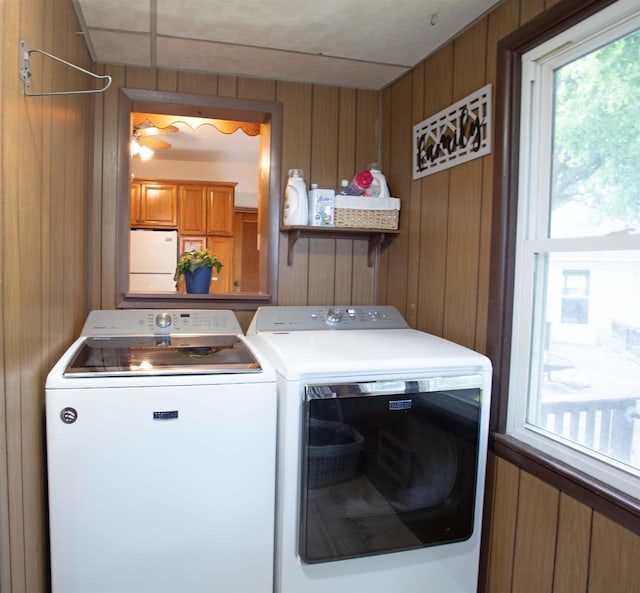 N3225 County Road K, Mauston, WI 53948 - washroom featuring separate washer and dryer and wood walls