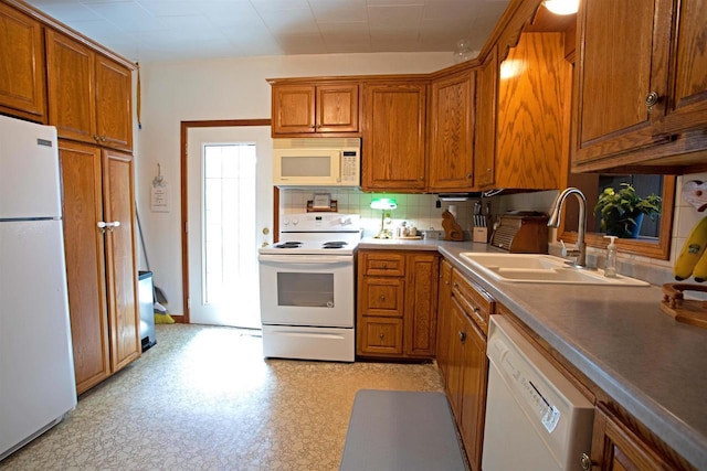 N3225 County Road K, Mauston, WI 53948 - kitchen featuring white appliances, brown cabinets, and tasteful backsplash