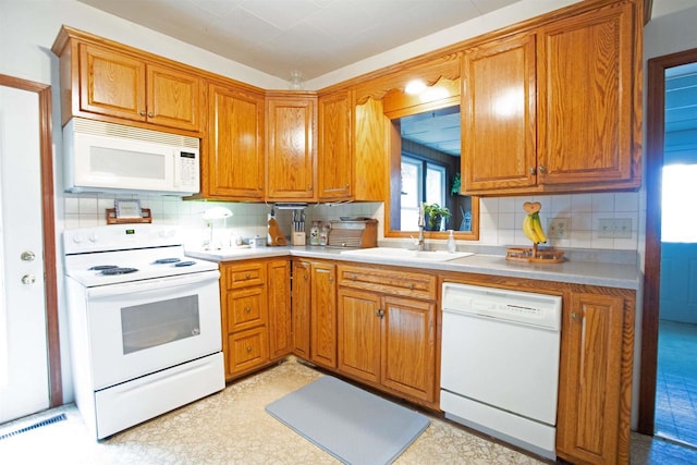 N3225 County Road K, Mauston, WI 53948 - kitchen featuring white appliances, decorative backsplash, and brown cabinetry