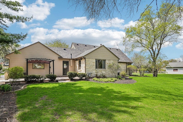 2040 San Fernando Dr, Elm Grove, WI 53122 - back of property with stone siding, a lawn, and a shingled roof