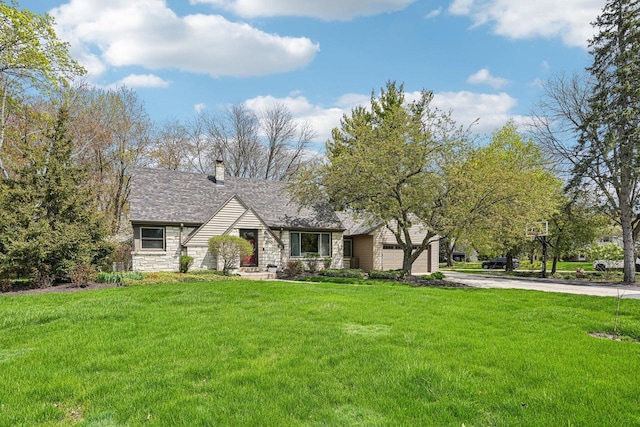 2040 San Fernando Dr, Elm Grove, WI 53122 - view of front of home featuring stone siding, concrete driveway, a front lawn, and a garage