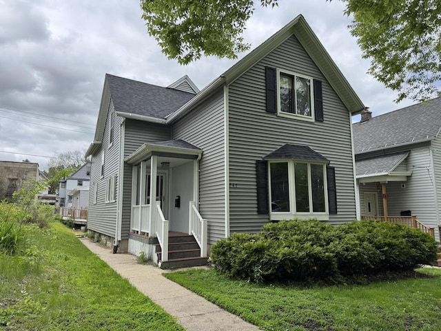 747 S 37th St, Milwaukee, WI 53215 - traditional-style home with a front lawn and a shingled roof