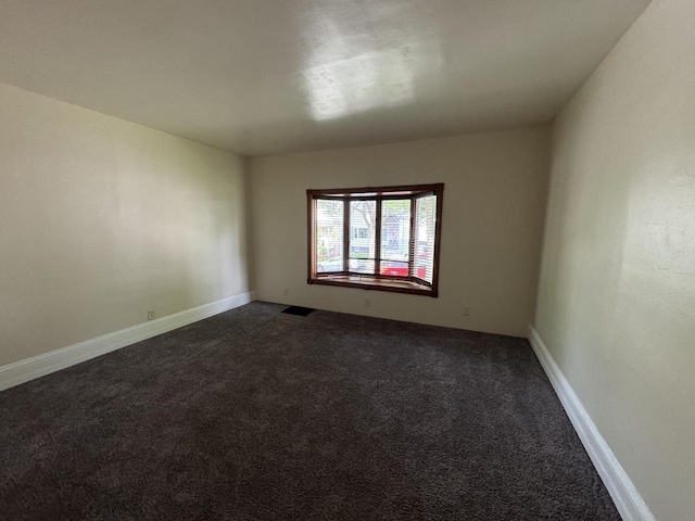 747 S 37th St, Milwaukee, WI 53215 - spare room featuring dark colored carpet