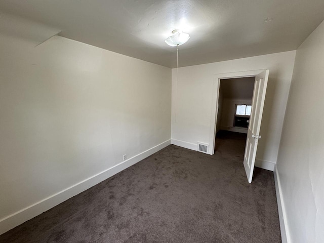 747 S 37th St, Milwaukee, WI 53215 - spare room featuring baseboards and dark colored carpet