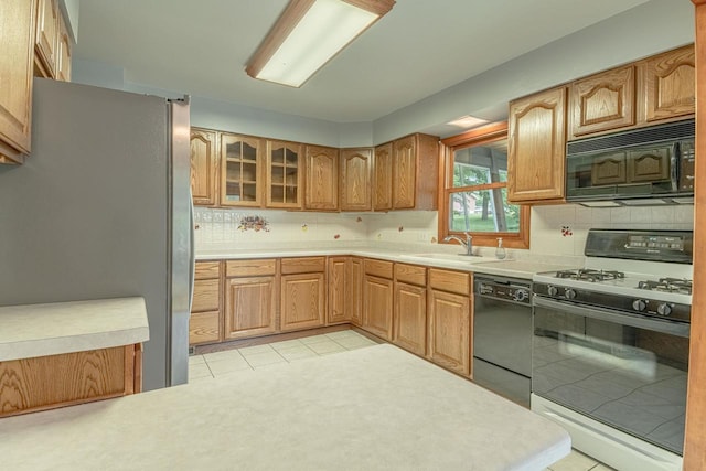 619 4th Ave, New Glarus, WI 53574 - kitchen featuring black appliances, backsplash, light countertops, light tile patterned flooring, and glass insert cabinets