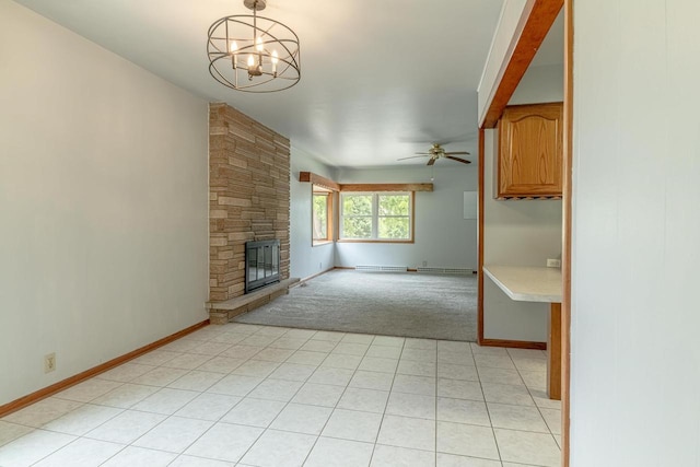 619 4th Ave, New Glarus, WI 53574 - unfurnished living room featuring light colored carpet, a chandelier, a fireplace, ceiling fan, and a baseboard radiator