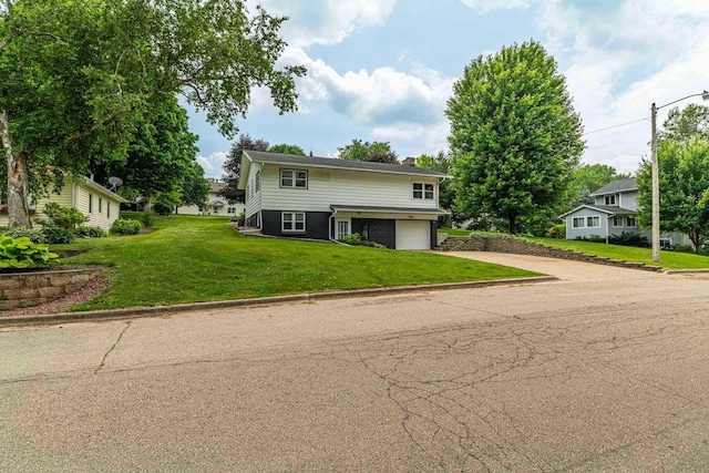 619 4th Ave, New Glarus, WI 53574 - traditional home featuring concrete driveway, a garage, a chimney, and a front yard