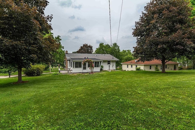619 4th Ave, New Glarus, WI 53574 - rear view of house with a lawn, a chimney, and a sunroom