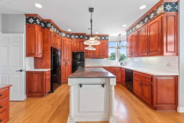 4047 Scenic Rd, Jackson, WI 53037 - kitchen with black appliances, light wood-style floors, a kitchen island, decorative backsplash, and recessed lighting