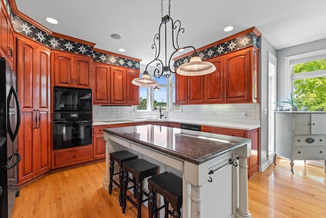4047 Scenic Rd, Jackson, WI 53037 - kitchen featuring black appliances, light wood-type flooring, backsplash, decorative light fixtures, and recessed lighting