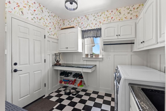 4047 Scenic Rd, Jackson, WI 53037 - washroom featuring cabinet space, washing machine and dryer, a decorative wall, dark floors, and wallpapered walls