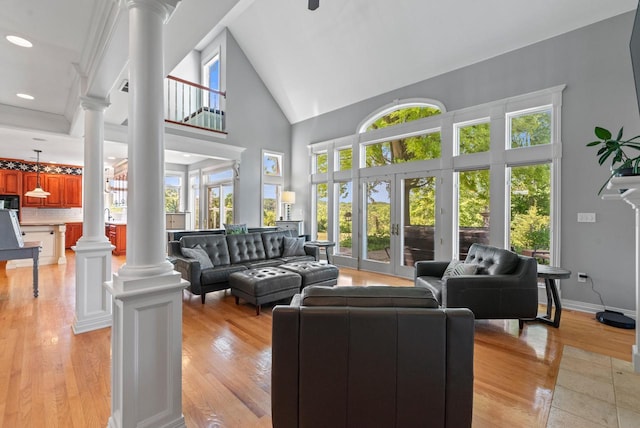 4047 Scenic Rd, Jackson, WI 53037 - living area with decorative columns, high vaulted ceiling, light wood-style floors, and recessed lighting