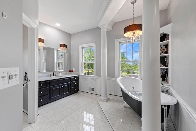 4047 Scenic Rd, Jackson, WI 53037 - full bathroom with decorative columns, a freestanding tub, wainscoting, a chandelier, and vanity
