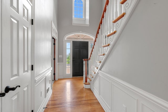 4047 Scenic Rd, Jackson, WI 53037 - entrance foyer with a decorative wall, stairs, healthy amount of natural light, light wood-style flooring, and a towering ceiling