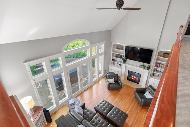 4047 Scenic Rd, Jackson, WI 53037 - living room with high vaulted ceiling, a fireplace, wood finished floors, and a ceiling fan