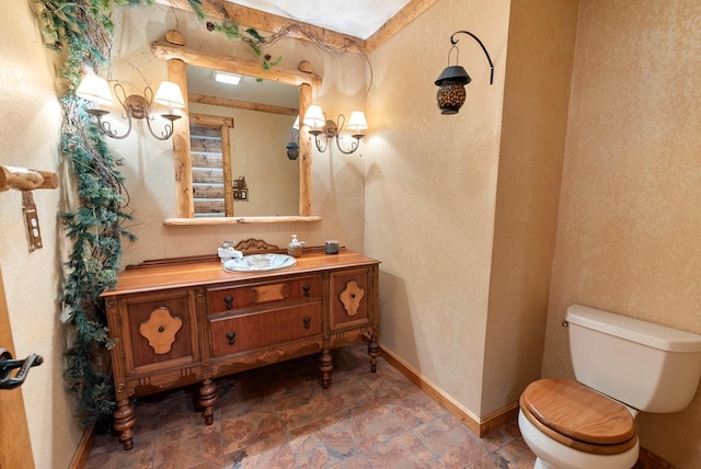 4047 Scenic Rd, Jackson, WI 53037 - bathroom featuring vanity, stone finish floors, and a textured wall