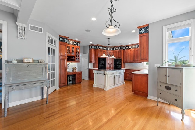 4047 Scenic Rd, Jackson, WI 53037 - kitchen featuring light wood-style floors, backsplash, a center island, recessed lighting, and hanging light fixtures