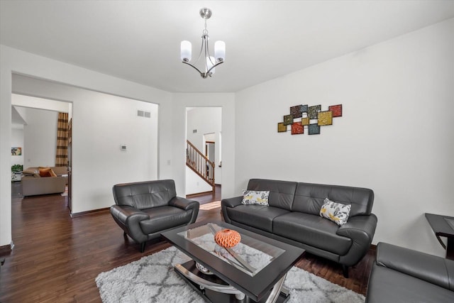 10870 N Spartan Cir, Mequon, WI 53097 - living room featuring wood finished floors, stairs, and a chandelier