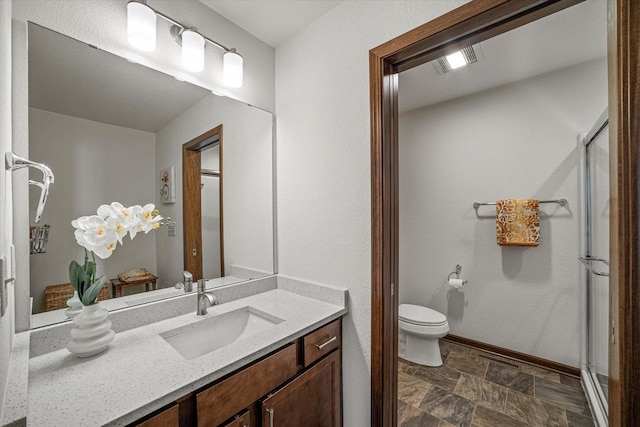 10870 N Spartan Cir, Mequon, WI 53097 - full bathroom featuring vanity, stone finish flooring, and a shower with shower door