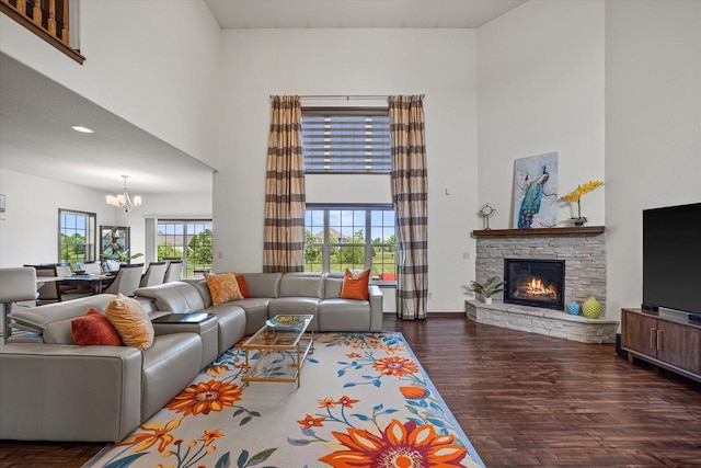 10870 N Spartan Cir, Mequon, WI 53097 - living room with a towering ceiling, a chandelier, a fireplace, and wood finished floors