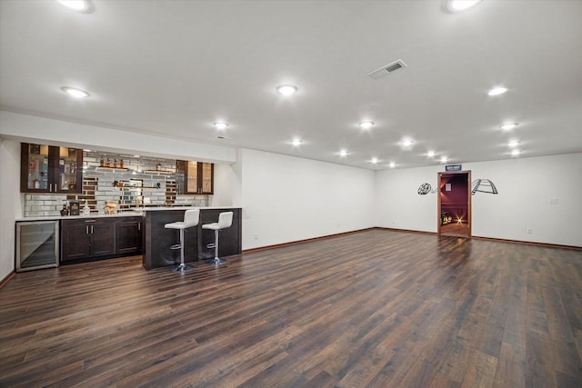 10870 N Spartan Cir, Mequon, WI 53097 - indoor wet bar with wine cooler, dark wood-style flooring, recessed lighting, and decorative backsplash