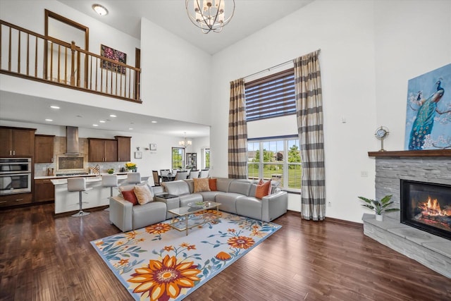 10870 N Spartan Cir, Mequon, WI 53097 - living area with a towering ceiling, a chandelier, a fireplace, and dark wood-type flooring