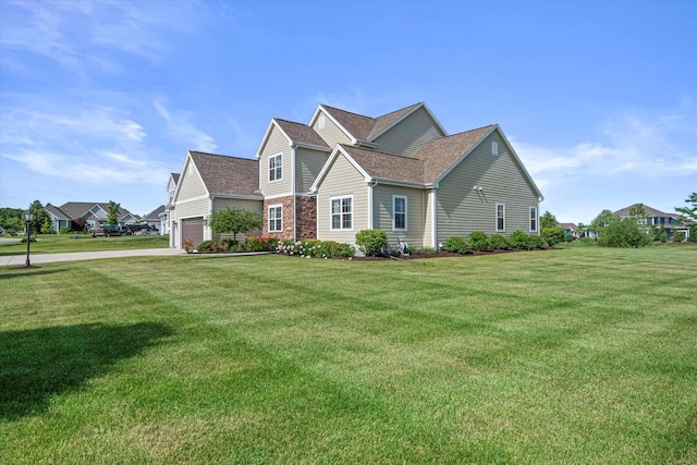 10870 N Spartan Cir, Mequon, WI 53097 - traditional-style home featuring a front yard, roof with shingles, a garage, and driveway