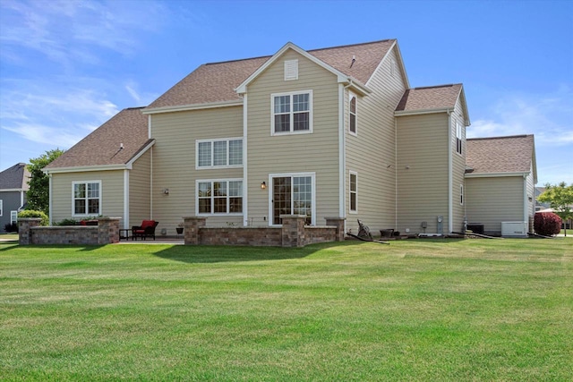 10870 N Spartan Cir, Mequon, WI 53097 - rear view of house with a lawn, roof with shingles, and a patio area
