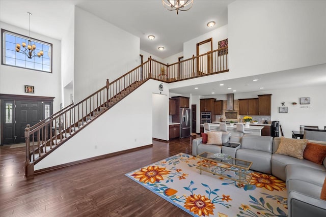 10870 N Spartan Cir, Mequon, WI 53097 - living area featuring a high ceiling, a chandelier, stairs, and dark wood-style flooring