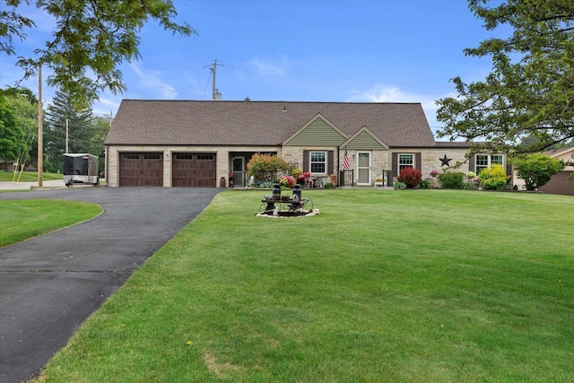 20903 W Main St, Lannon, WI 53046 - view of front of property featuring a garage, stone siding, asphalt driveway, a front lawn, and roof with shingles