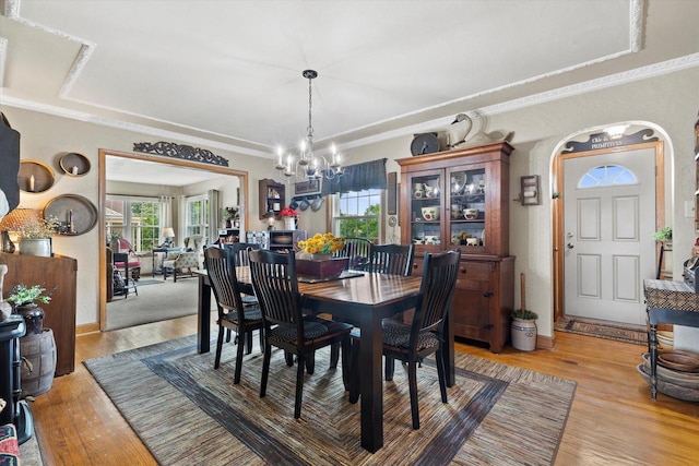 20903 W Main St, Lannon, WI 53046 - dining area featuring arched walkways, a chandelier, light wood-type flooring, and ornamental molding