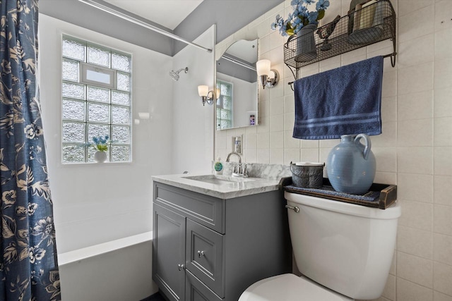 20903 W Main St, Lannon, WI 53046 - bathroom with vanity, shower / bath combination with curtain, and decorative backsplash