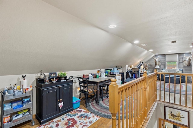 20903 W Main St, Lannon, WI 53046 - bonus room with lofted ceiling, wood finished floors, and a textured ceiling