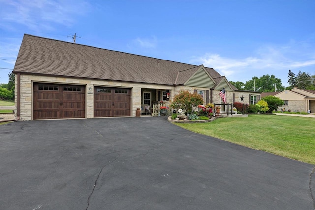 20903 W Main St, Lannon, WI 53046 - view of front of property with stone siding, a front yard, asphalt driveway, and an attached garage