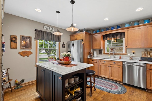 20903 W Main St, Lannon, WI 53046 - kitchen featuring stainless steel appliances, open shelves, light wood-style floors, hanging light fixtures, and a center island