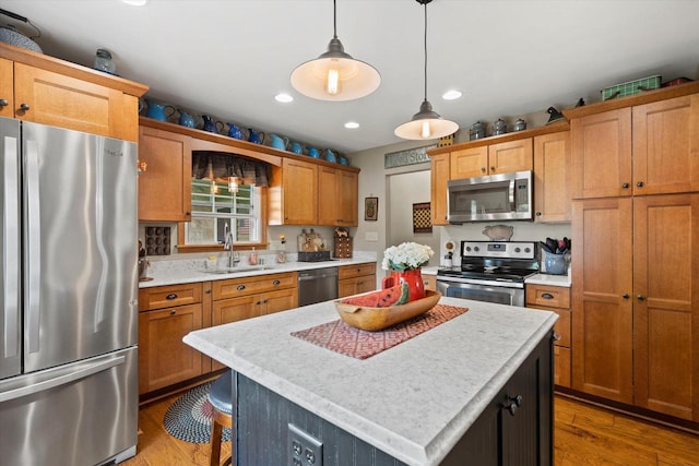 20903 W Main St, Lannon, WI 53046 - kitchen with stainless steel appliances, light countertops, light wood-type flooring, decorative light fixtures, and recessed lighting