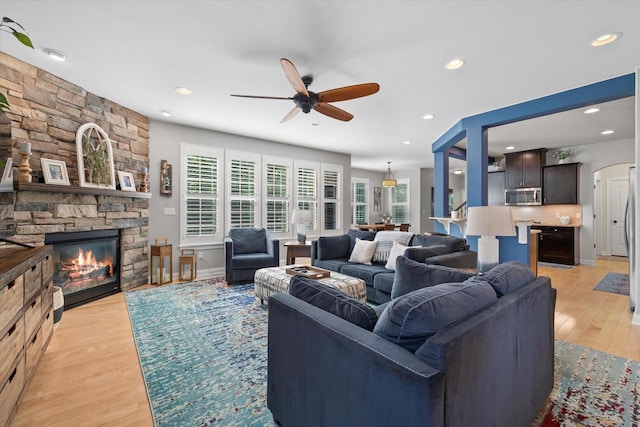 8061 S River Ln, Franklin, WI 53132 - living room featuring ceiling fan, a stone fireplace, light wood finished floors, and recessed lighting