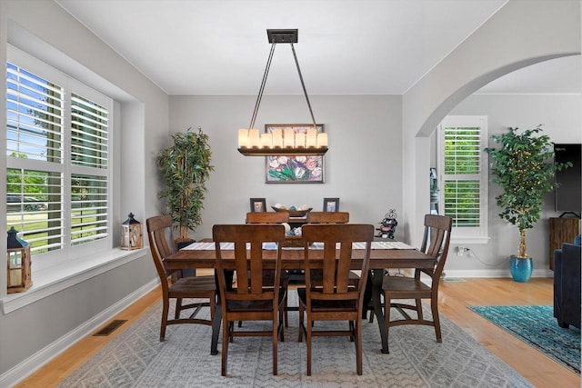 8061 S River Ln, Franklin, WI 53132 - dining room featuring light wood finished floors and arched walkways