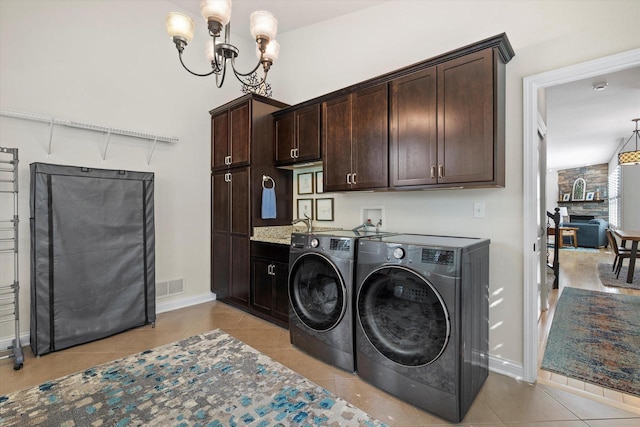 8061 S River Ln, Franklin, WI 53132 - laundry room with cabinet space, separate washer and dryer, a chandelier, and light tile patterned floors