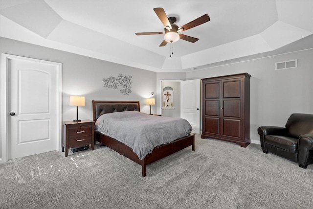 8061 S River Ln, Franklin, WI 53132 - bedroom with a tray ceiling, light carpet, and a ceiling fan