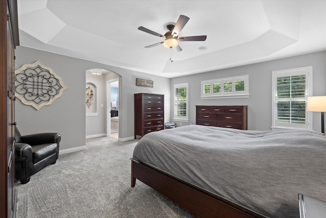 8061 S River Ln, Franklin, WI 53132 - bedroom with a tray ceiling, arched walkways, carpet flooring, and ceiling fan