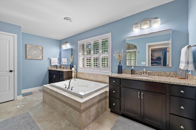 8061 S River Ln, Franklin, WI 53132 - bathroom with two vanities, a garden tub, tile patterned floors, and a shower